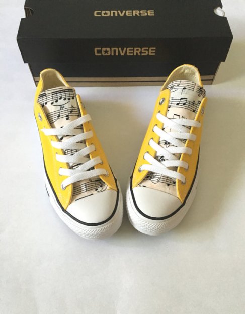 yellow convers shoes with musical fabric added to the tongue.